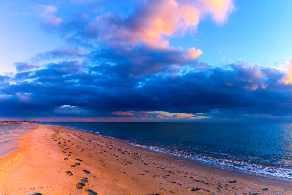 Evening. Footprints in the sea sand (Seascape)