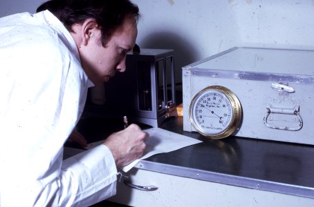 1974. Tom Gregg records data for three different temperature and humidity checks: hygrothermograph; sling slycrometer, and separate thermometer-hygrometer. Douglas-fir tussock moth control project. photo