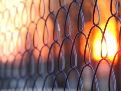 Sunset through a chain link fence photo