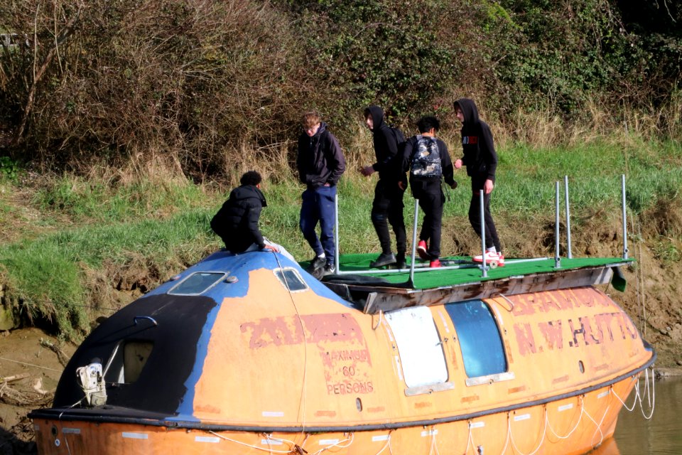 Lewes kids social distancing on someone else's boat. Lewes, East Sussex, UK