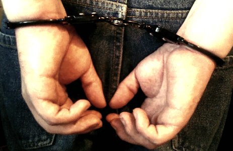 guy handcuffed behing back photo