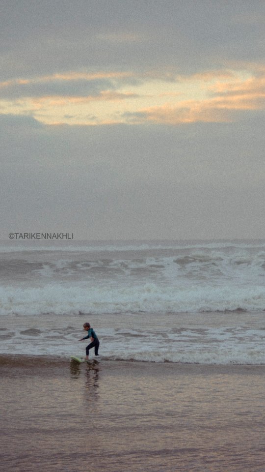 a young boy surfing