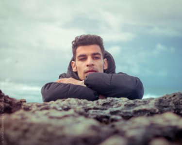 Portrait of an attractive young man on a tropical beach. Handsome man on the coast photo