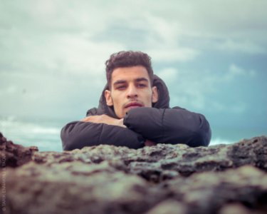 Portrait of an attractive young man on a tropical beach. Handsome man on the coast