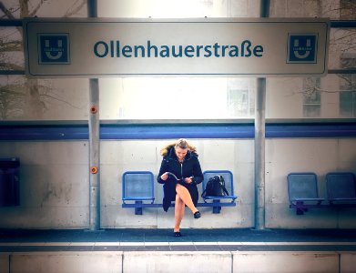 Woman reading on train station photo