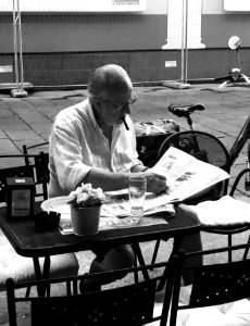 Portret of old man reading the newspaper, Bologna Italy photo