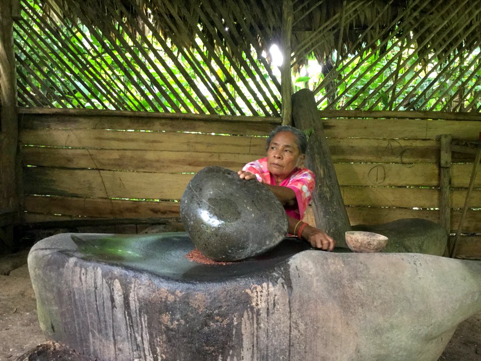 Stone grinding cacao into chocolate.