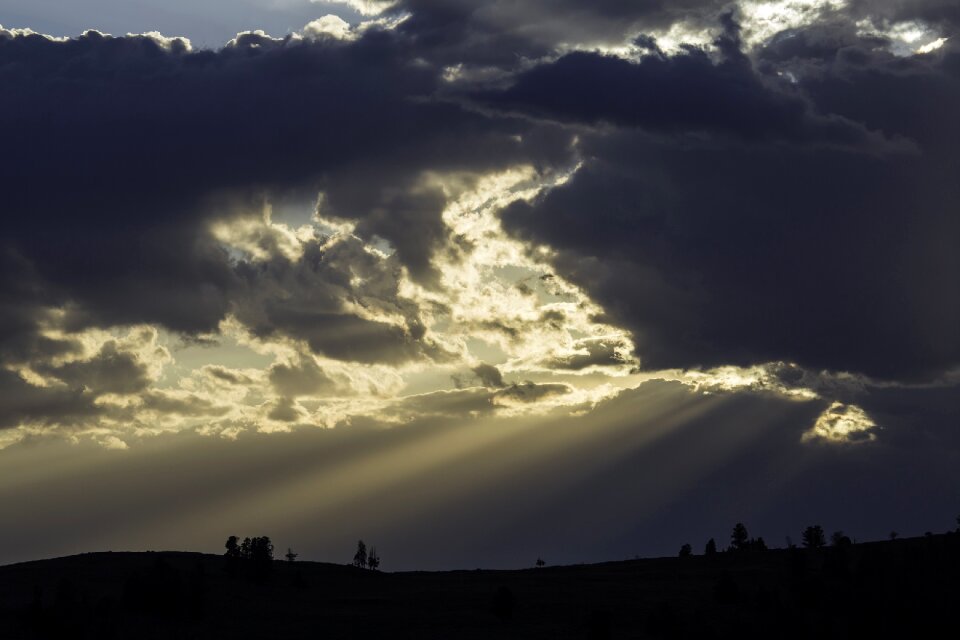 Clouds crepuscular rays silhouettes photo