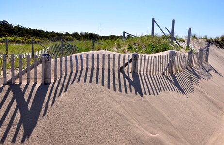 Shadows fence patterns sand photo