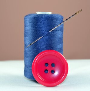 Needle sewing spool of thread photo