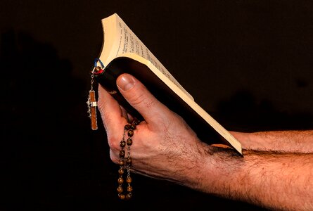 Man hand hold prayer book faith