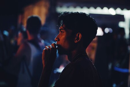 Person smoking blue smoke photo