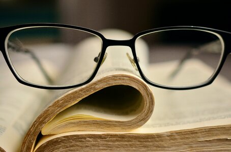 Holy scripture book pages reading glasses photo
