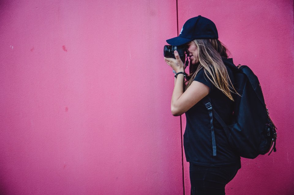 woman holding camera taking photo photo