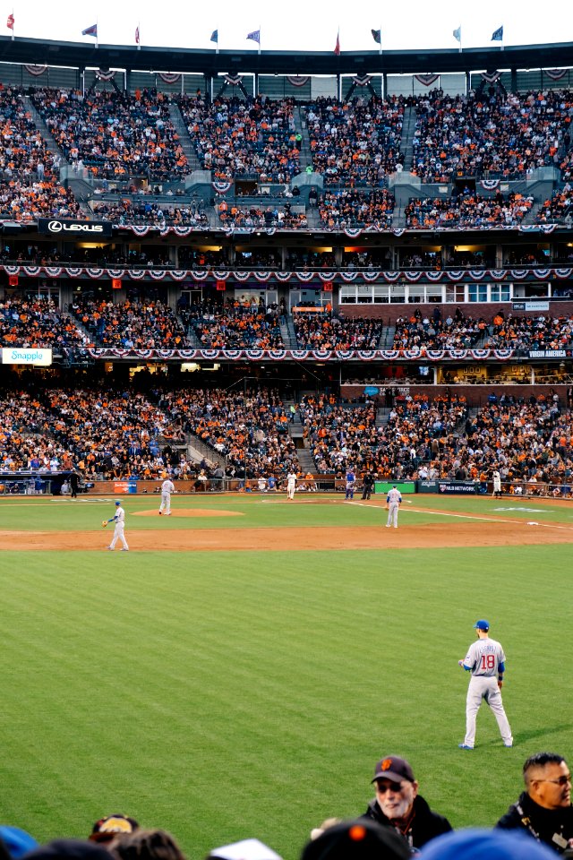 photo of baseball players in stadium during daytime