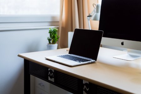 silver laptop on desk beside silver iMac photo