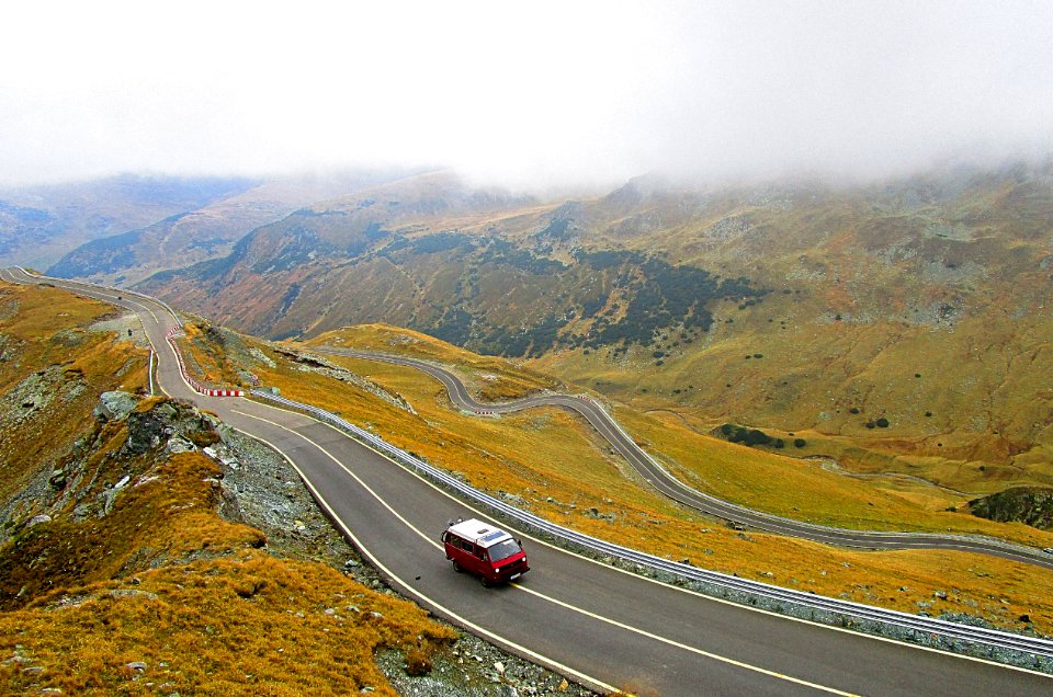 aerial photography of white and red vehicle on road during daytime