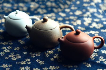 three assorted-color teapots photo