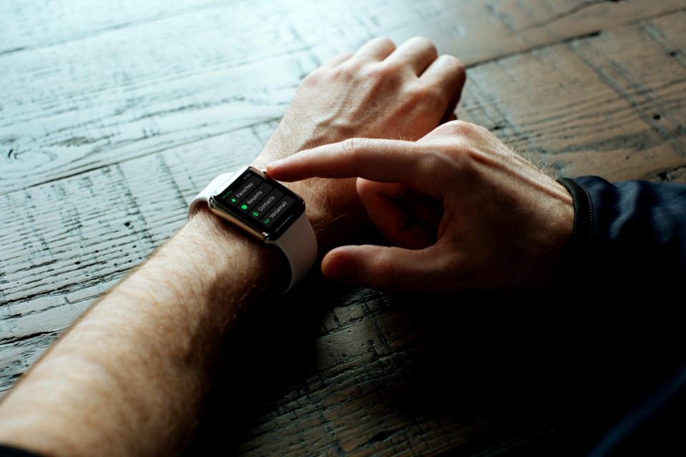 person touching Apple watch