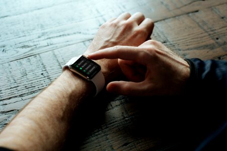 person touching Apple watch