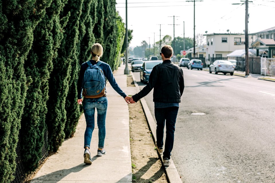 man and woman walking on pathway during daytime