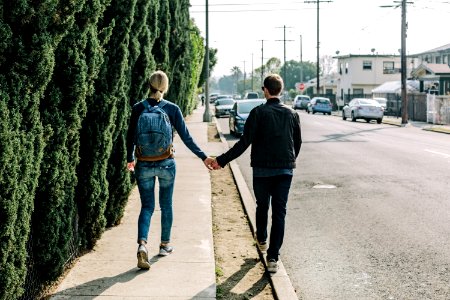 man and woman walking on pathway during daytime photo