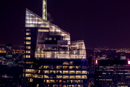 high-rise buildings with lights on during nighttime photo