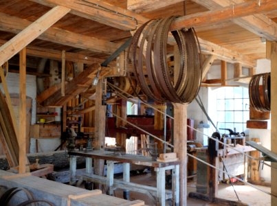 brown belts hanged in brown wooden post inside building
