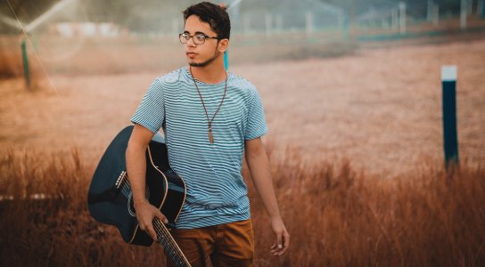 man holding cutwaya acoustic guitar photo