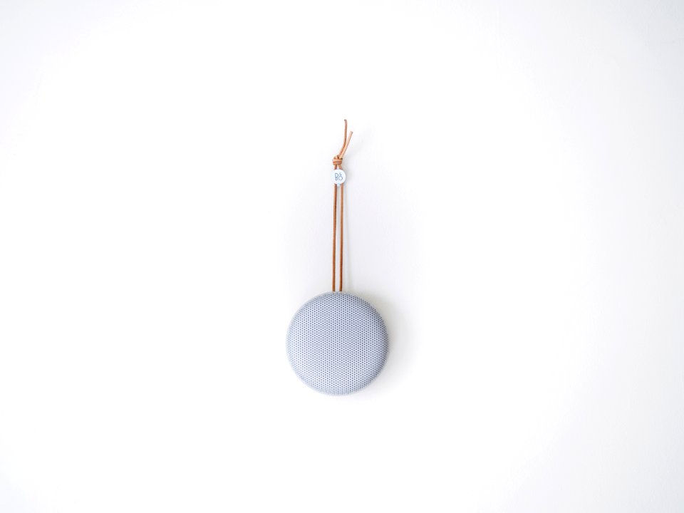 round grey hanging decor on white wall