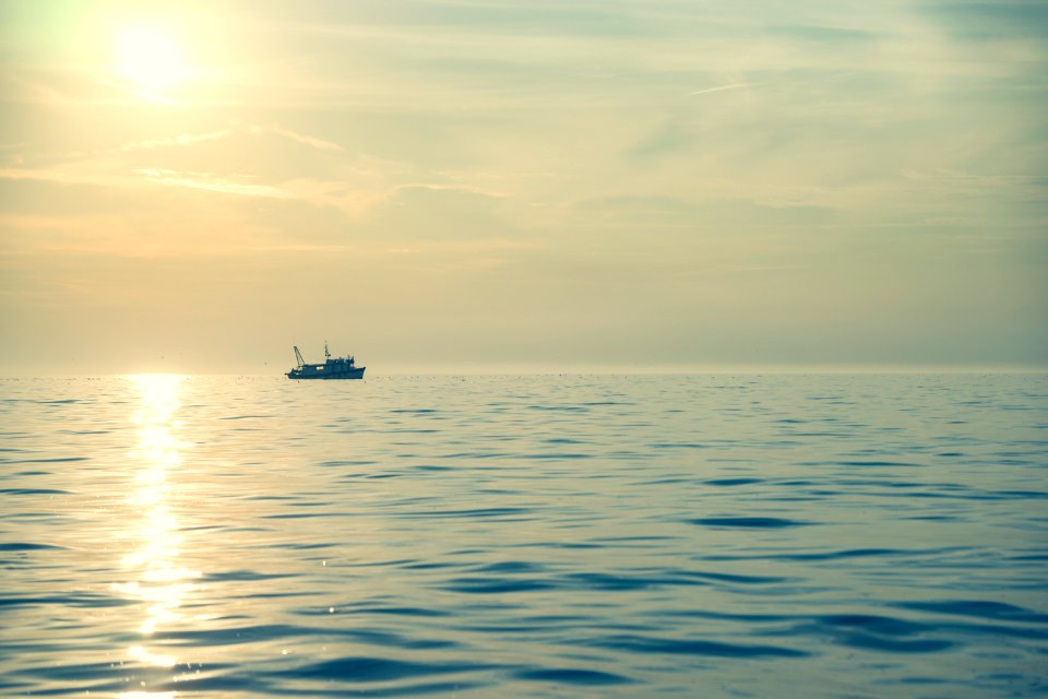 boat on body of water under sun