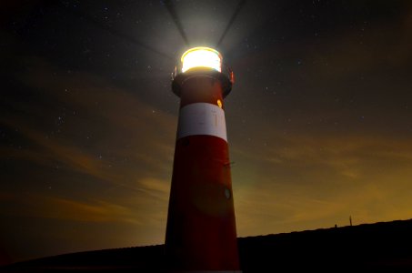 low angle view of red and white lighthouse photo