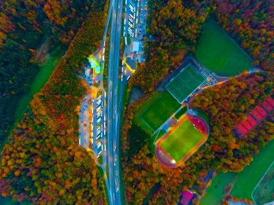 aerial photography of road, soccer field, and football field