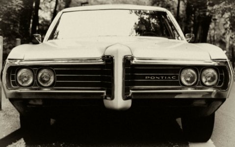 black Pontiac car on gray road photo