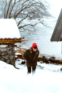 man walking on snow covered land photo