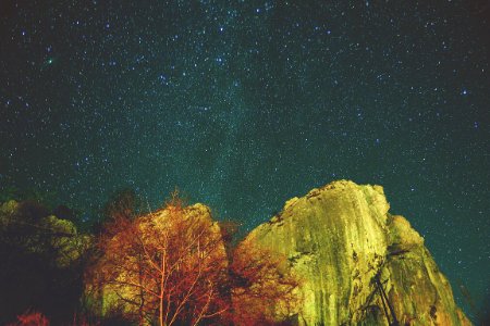 night sky with stars above mountain photo