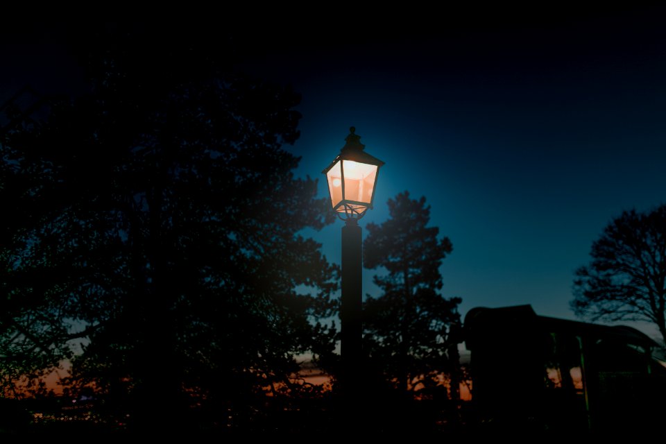 turned-on lantern post