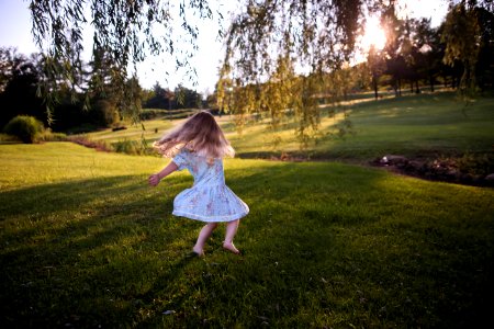 girl dancing on green grass field photo