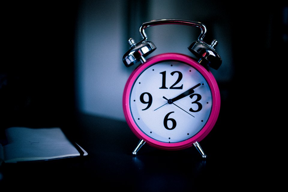 pink bell alarm clock showing 2:10