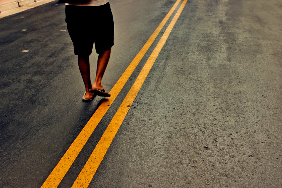 person walking in the middle of the street