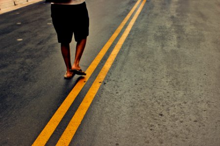 person walking in the middle of the street