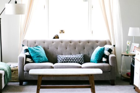 brown and white wooden table beside sofa chair photo