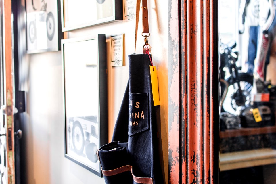 black and brown bag hanged beside wall