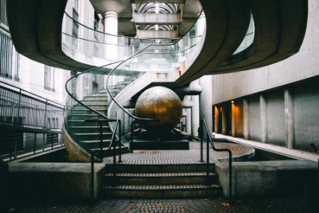 landscape photography of grey staircase with globe under photo