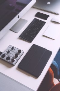flat lay photography of black iPad case, Apple wireless keyboard, iMac on white table photo