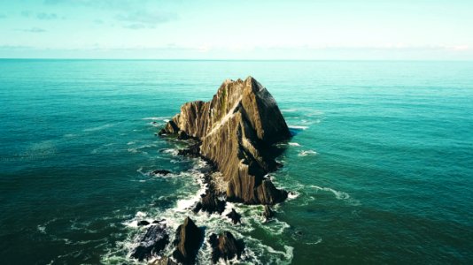 gray stone in body of water