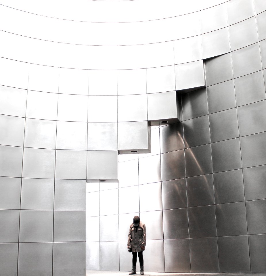 person standing under metal block building