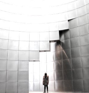 person standing under metal block building