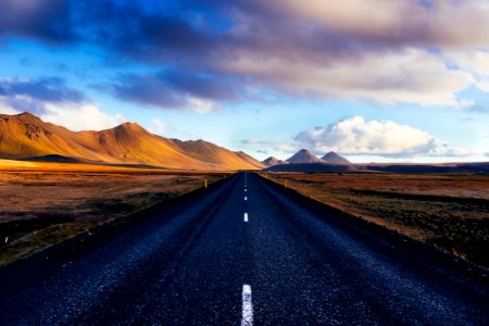 black concrete road with distance to mountains