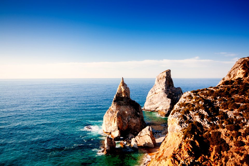 rock formations on sea at daytime